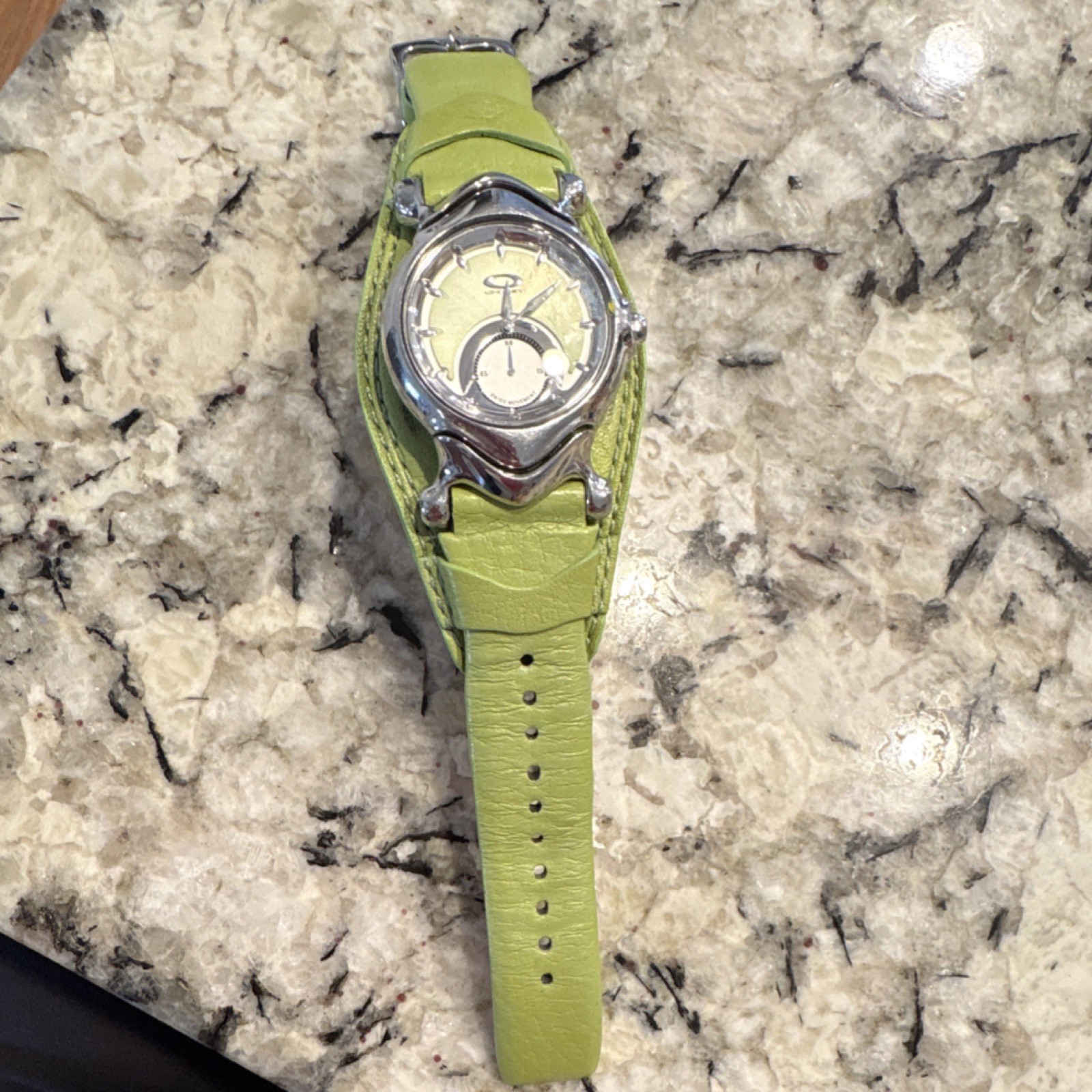 Oakley Unisex Green Leather Strap Swiss Quartz Wristwatch Silver Oval Dial