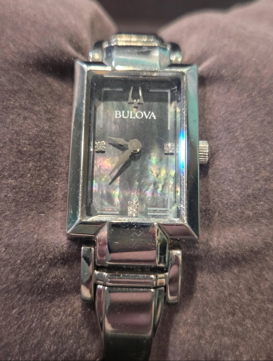 Bulova silver watch with rectangular face and diamond accents