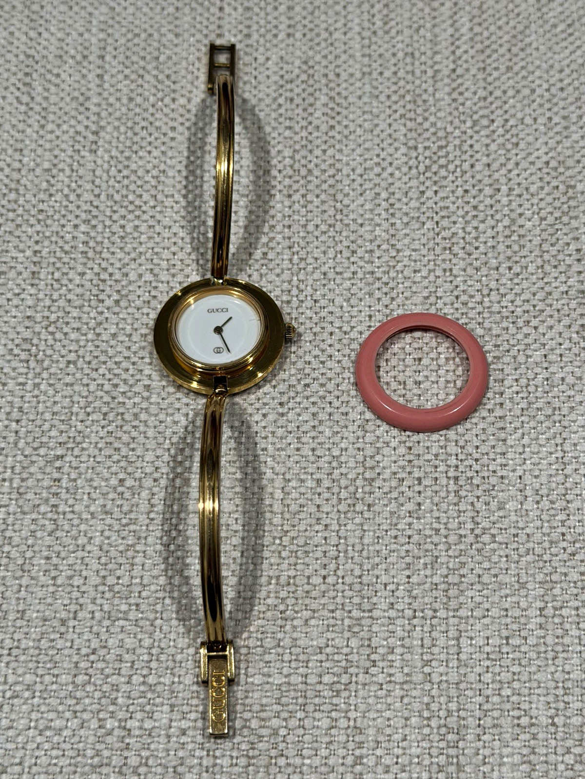 Gucci 1100-L Swiss Made Quartz Gold Tone Bangle Watch Pink Bezel White Dial