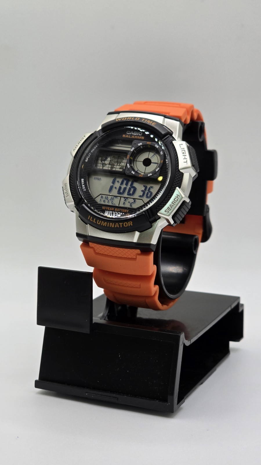 Casio Men’s Digital Watch with Black Dial & Orange Strap – AE1000W-4BV