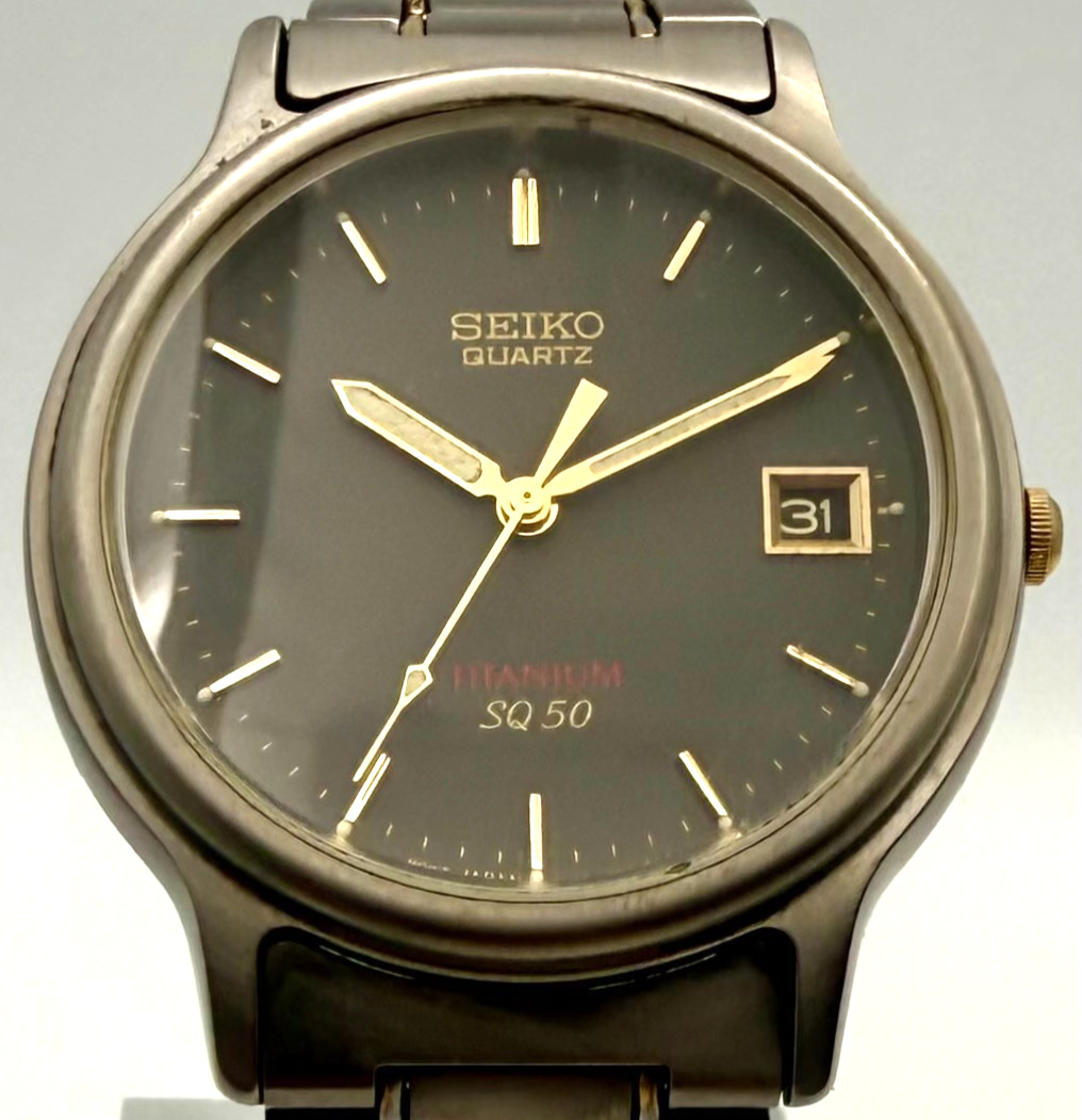 Seiko SQ50 Titanium Quartz Watch Ref 7N42 F060 Gold Accents Date Mens