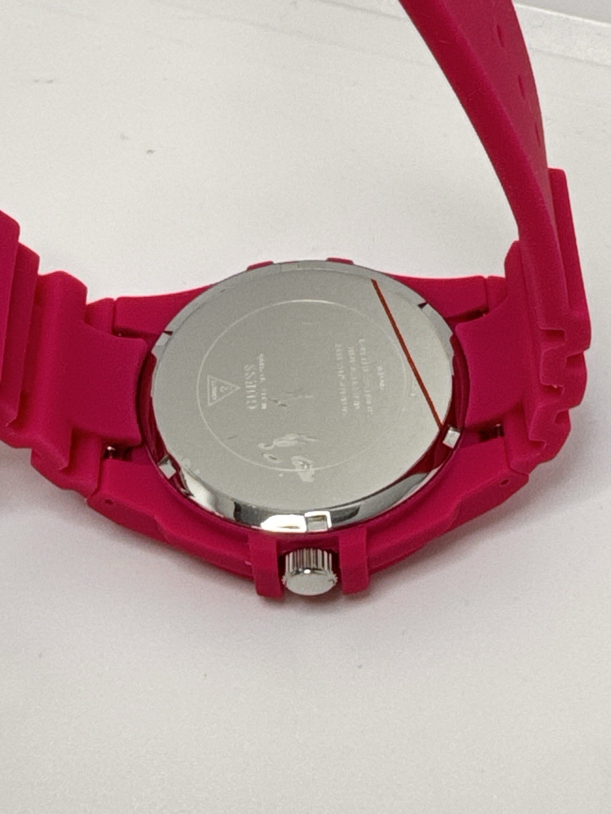 GUESS Ladies Pink Rubber Band Watch with a White Analog Dial and Multicolor
