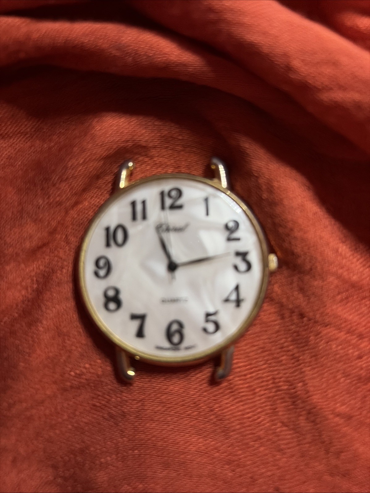 Non Working Chiral Quartz Watch With White Dial And Black Numerals. No Band